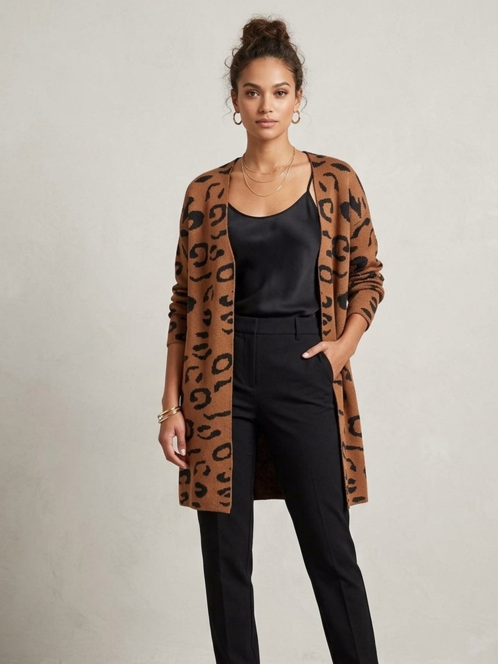 Leopard print cardigan features a slouchy, open-front design with long sleeves